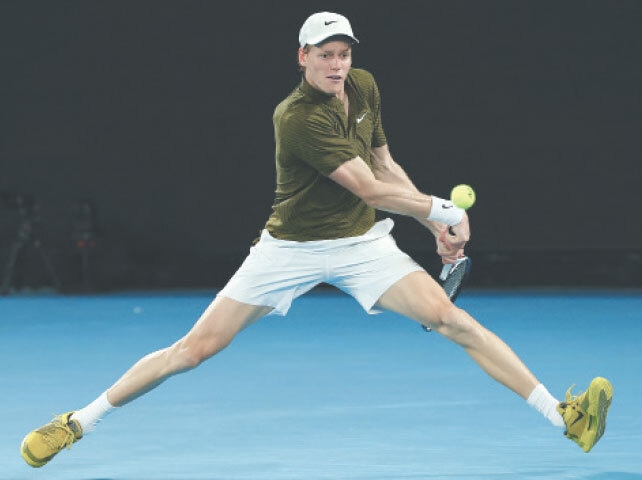 ITALY’S Jannik Sinner hits a return to Novak Djokovic of Serbia during their Australian Open semi-final at Melbourne Park on Friday.—Reuters