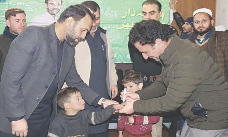 An official marks the finger of a child after administering vaccine at the office of the additional deputy commissioner in Pattan area of Lower Kohistan district. — Dawn An official marks the finger of a child after administering vaccine at the office of the additional deputy commissioner in Pattan area of Lower Kohistan district. — Dawn