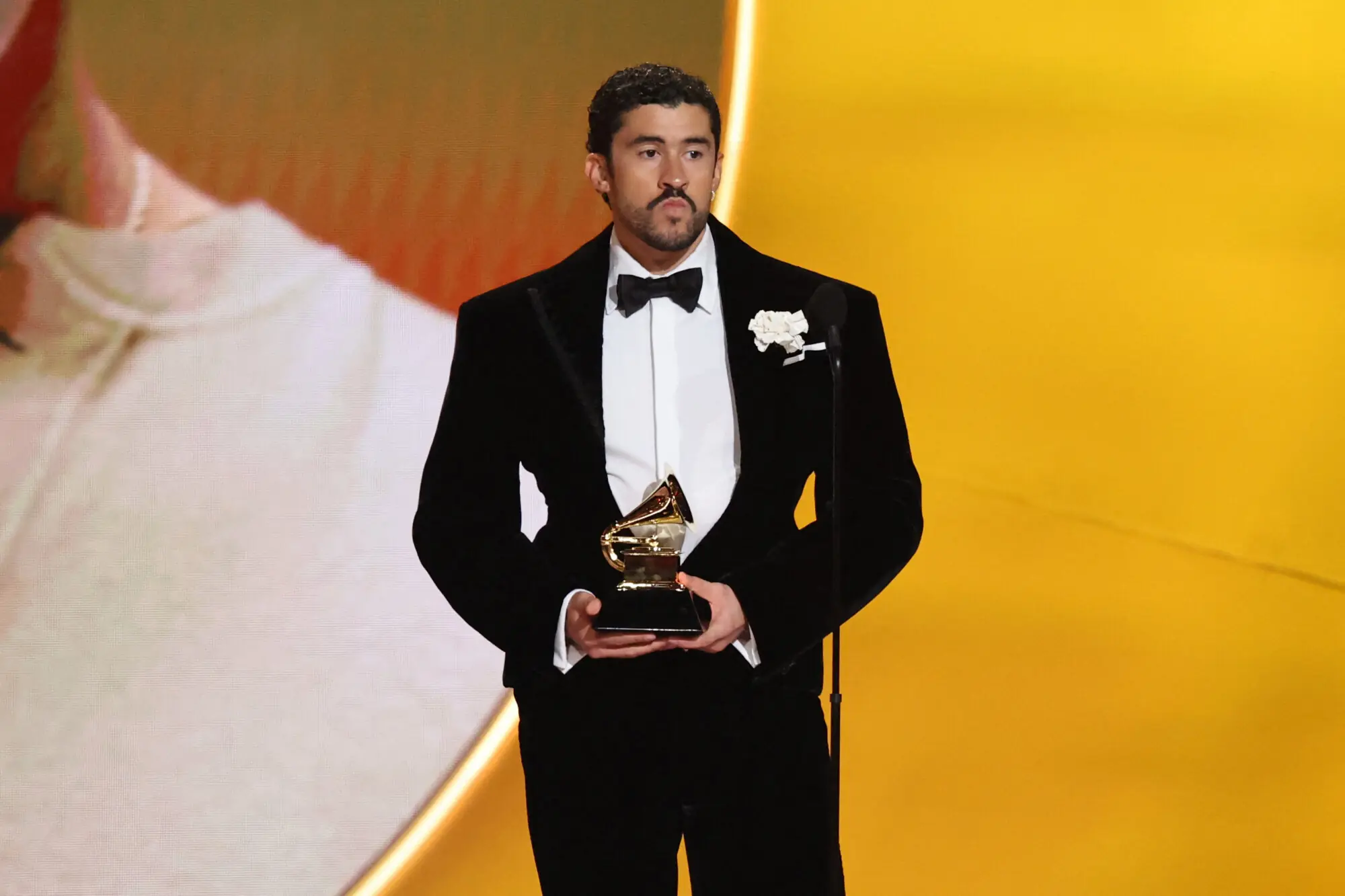 Bad Bunny with one of his three Grammys of the night. Photo: Reuters