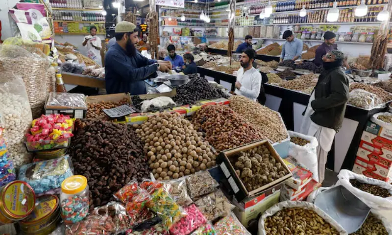 People buy dry fruits at a market in Karachi, Pakistan February 1, 2023. &mdash; Reuters
