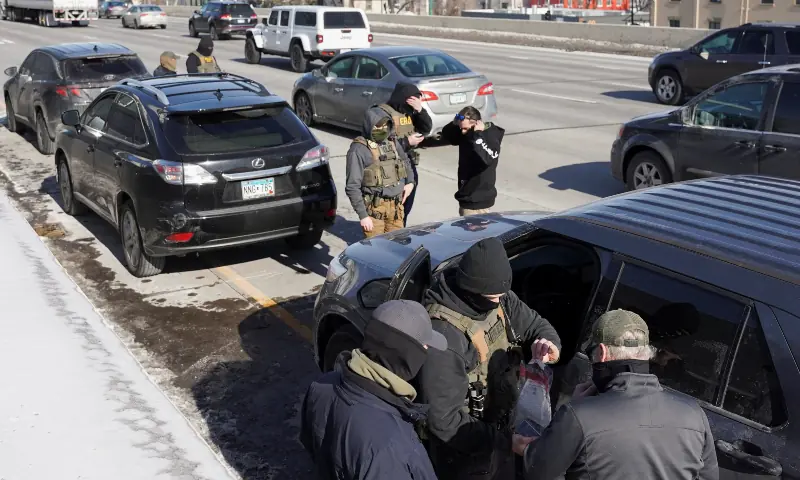 Federal immigration agents stand at Interstate 35W, while conducting immigration enforcement tasks in Minneapolis, Minnesota, US on Feb 3, 2026. &mdash; Reuters