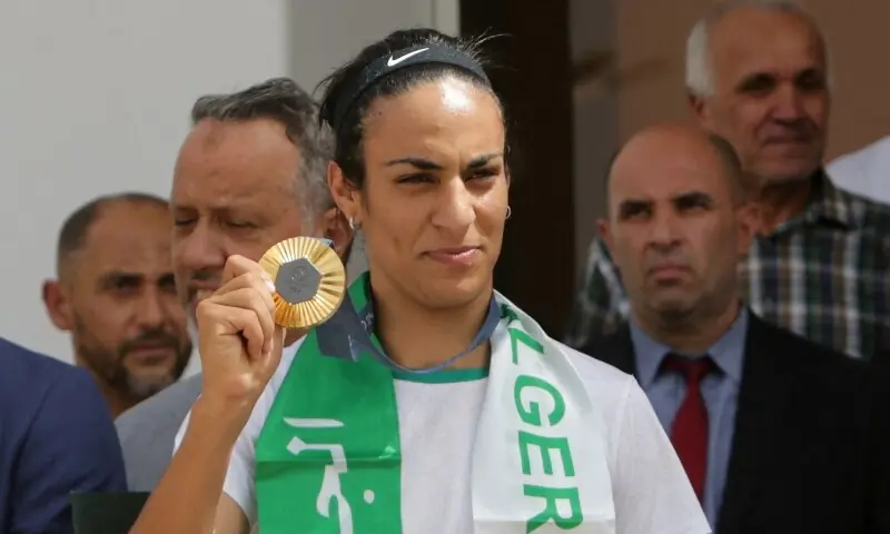 Algerian boxer Imane Khelif, who won the gold medal in the women&rsquo;s welterweight boxing at the Olympics, holds her medal upon her arrival at the airport in Algiers, Algeria on August 12, 2024. &mdash; Reuters/File