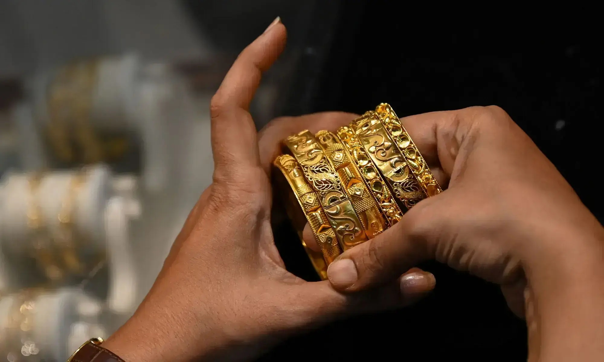Picture taken on August 11 2021 shows a customer handling gold bracelets at a jewellery shop. &mdash; AFP/File