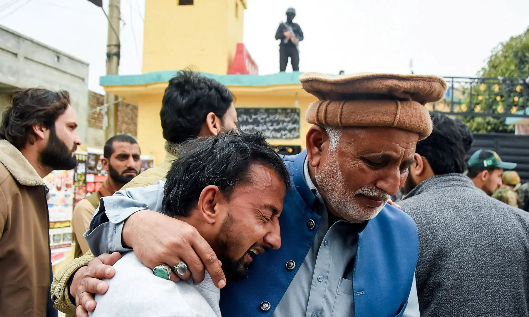 A grieving man is comforted after a deadly explosion at the Khadijah-tul-Kubra imambargah in Islamabad on February 6. &mdash; Reuters