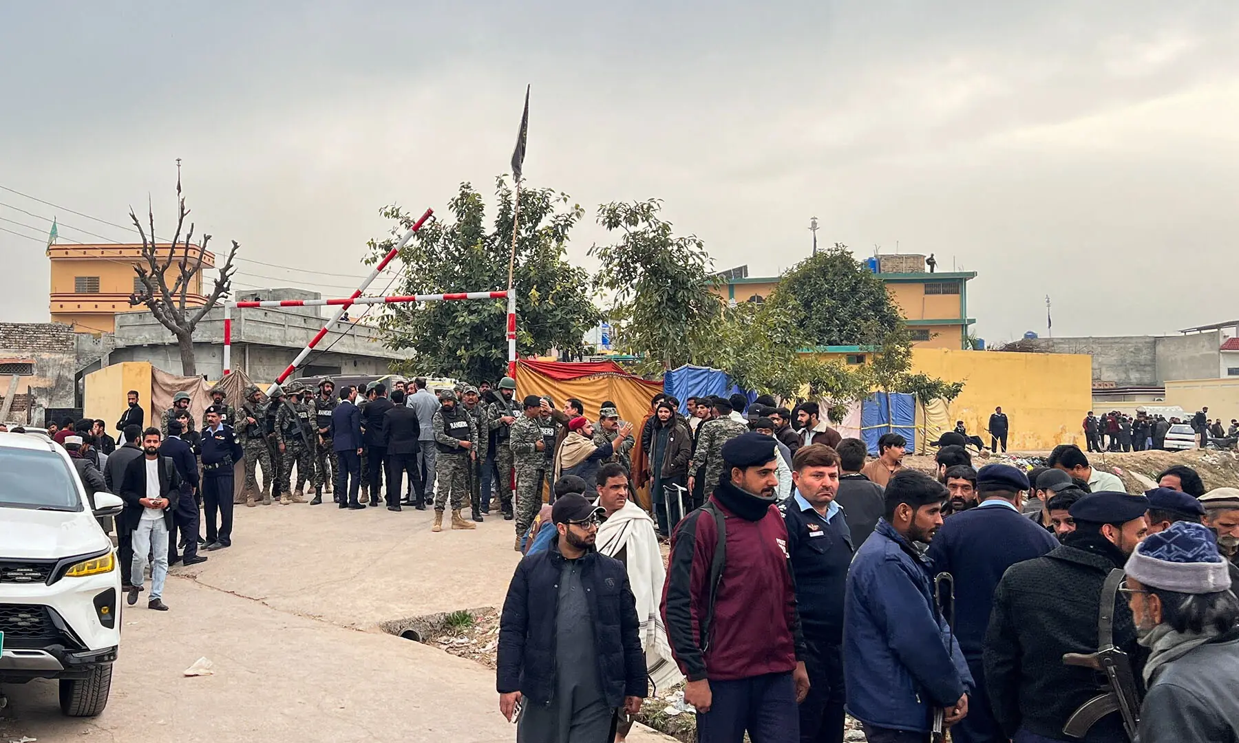 Paramilitary forces stand guard next to a crowd of people gathered near the Khadijah-tul-Kubra imambargah in Islamabad on, February 6. &mdash; Reuters