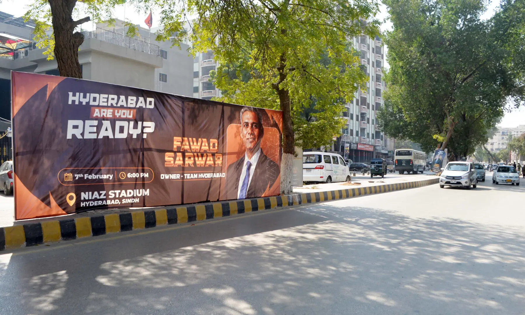A penaflex board with photo of Hyderabad PSL team owner Fawad Sarwar Khan affixed on Thandi Sarak infront of Niaz Stadium, Hyderabad. &mdash; Umair Ali Rajput