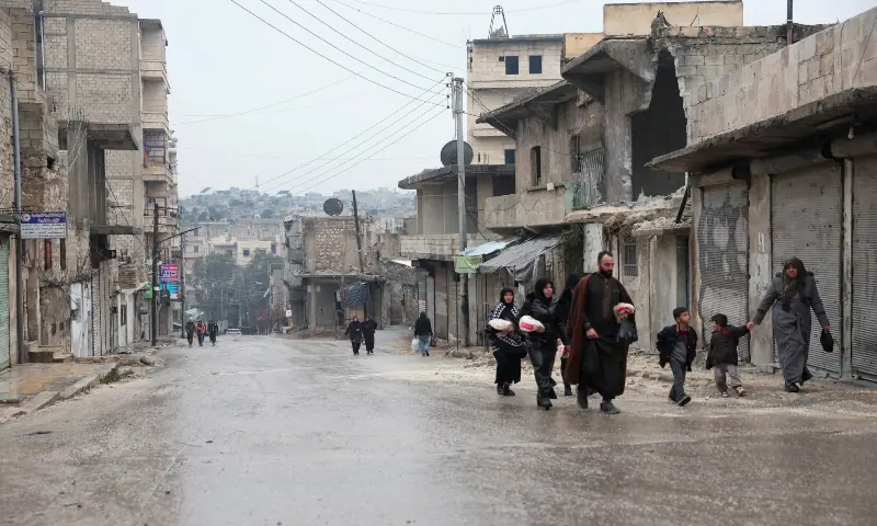 A family walks in the Al-sheikh Maqsoud neighbourhood, after the Kurdish-led Syrian Democratic Forces (SDF) fighters left Aleppo, in Aleppo, Syria on Jan 12, 2026. — Reuters/File A family walks in the Al-sheikh Maqsoud neighbourhood, after the Kurdish-led Syrian Democratic Forces (SDF) fighters left Aleppo, in Aleppo, Syria on Jan 12, 2026. — Reuters/File