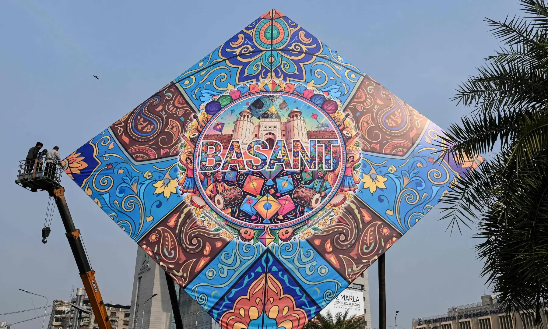 Workers install a large model of a kite celebrating the Basant festival in Lahore on Feb 3, 2026. — AFP Workers install a large model of a kite celebrating the Basant festival in Lahore on Feb 3, 2026. — AFP