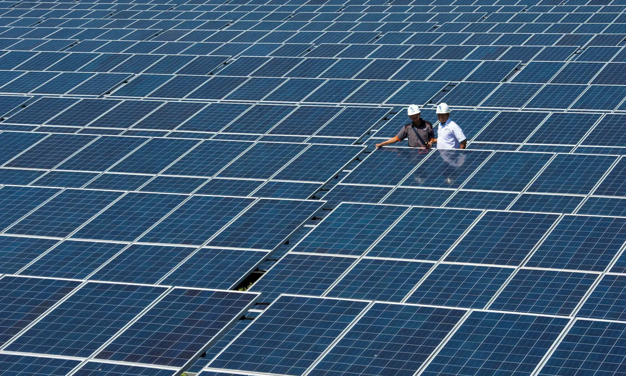 State Electricity Company officials stands between solar cell panels at the largest solar power plant in Indonesia, at Oelpuah village in Kupang. — Reuters/File State Electricity Company officials stands between solar cell panels at the largest solar power plant in Indonesia, at Oelpuah village in Kupang. — Reuters/File