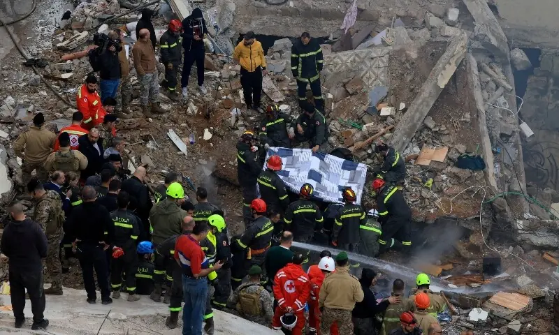 Rescue workers remove a body from under the rubble after a residential building collapsed in Tripoli, Lebanon, February 9, 2026. &mdash;Reuters