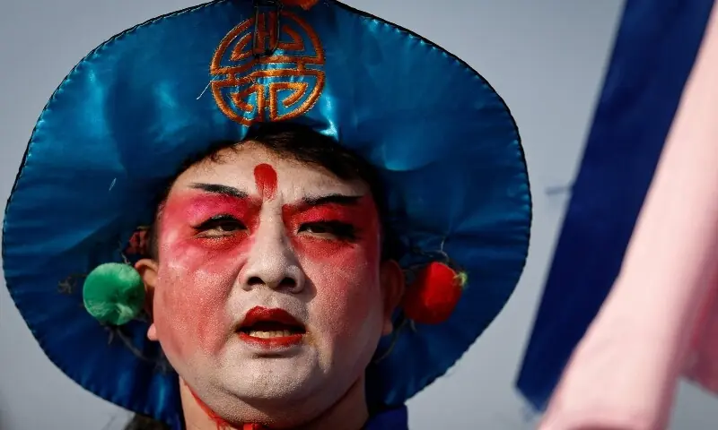 A folk artist performs at an outdoor market ahead of the Lunar New Year, in Beijing, China February 10, 2026. &mdash;Reuteres