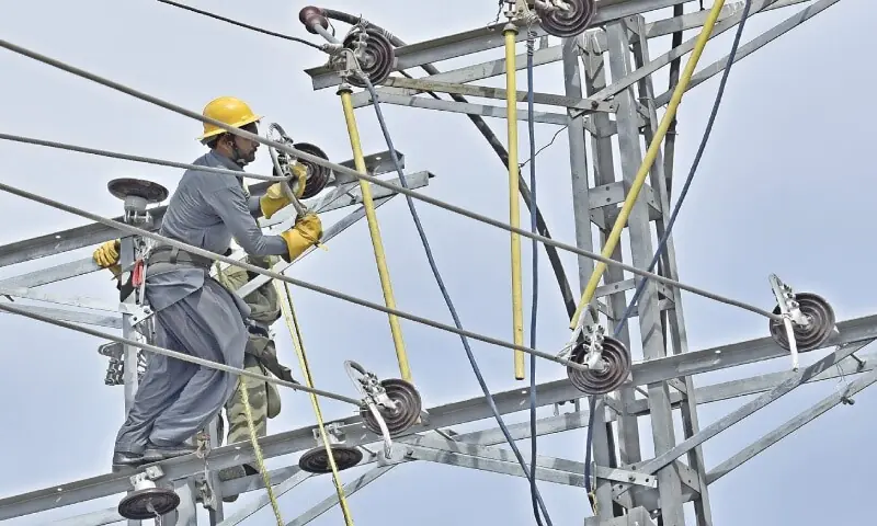 An electrician working on a power line. &mdash; White Star/File