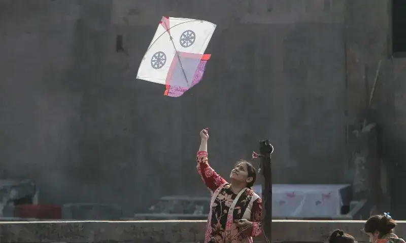 A woman flies a kite from a rooftop to mark Basant, a kite-flying festival, in Lahore, February 6. &mdash; Reuters