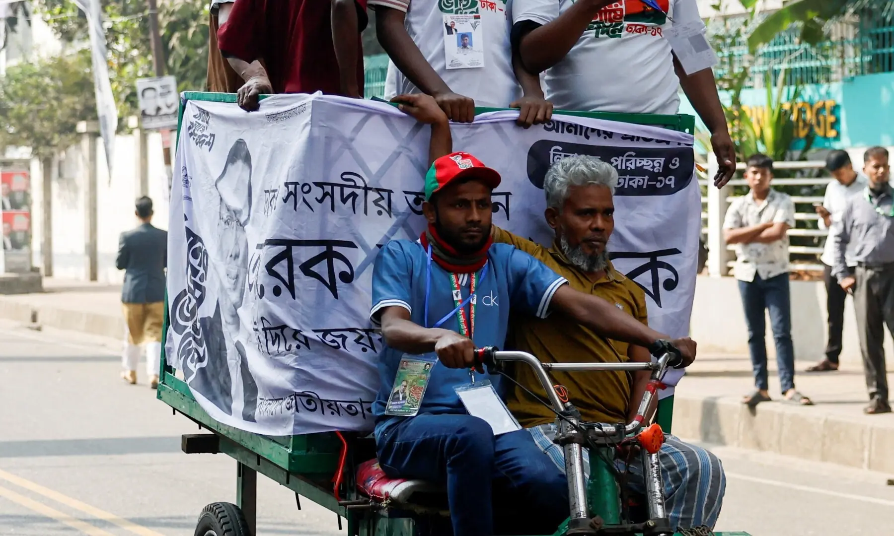 Supporters of the Bangladesh Nationalist Party (BNP) ride a vehicle outside the polling station during the 13th general election in Dhaka, Bangladesh, February 12, 2026.  &mdash;AFP