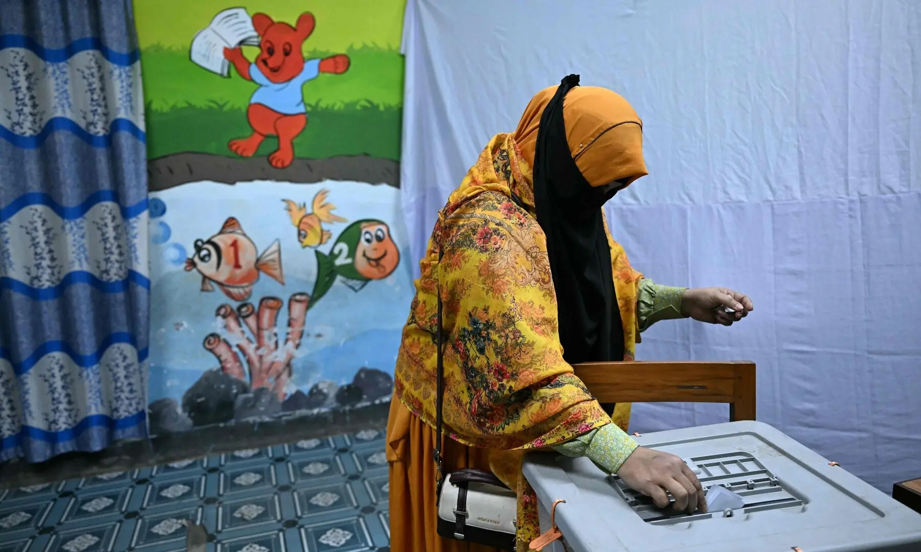 A woman casts her ballot at a polling station during Bangladesh&rsquo;s general election in Dhaka on February 12, 2026. &mdash;AFP