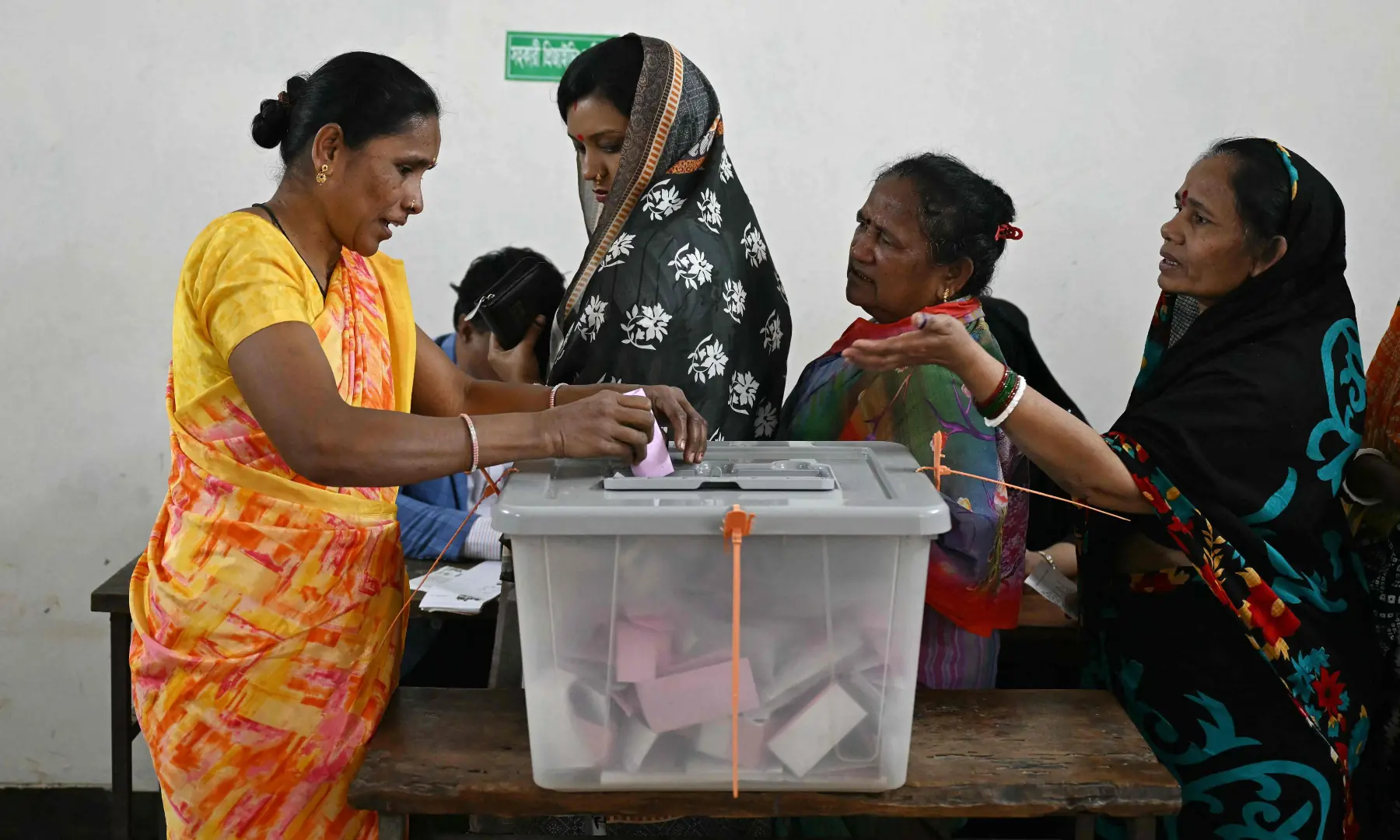A Bangladeshi Hindu woman (L) casts her ballot at a polling station during Bangladesh&rsquo;s general election in Dhaka on February 12. &mdash; AFP