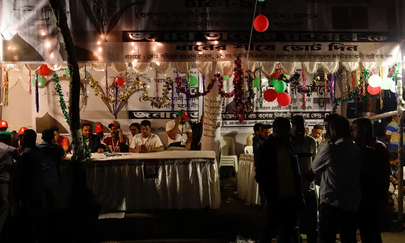 Supporters of the Bangladesh Nationalist Party (BNP) sit at a booth as they wait for the results of 13th general election near Gulshan party office, in Dhaka, Bangladesh on February 12. &mdash; Reuters
