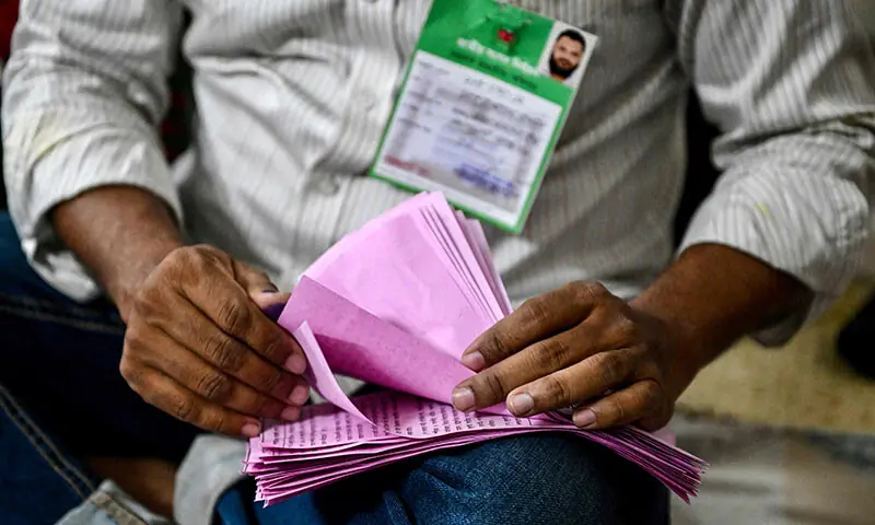 An electoral official counts referendum ballots as voting ends at a polling station during Bangladesh&rsquo;s general election in Dhaka on February 12. &mdash; AFP