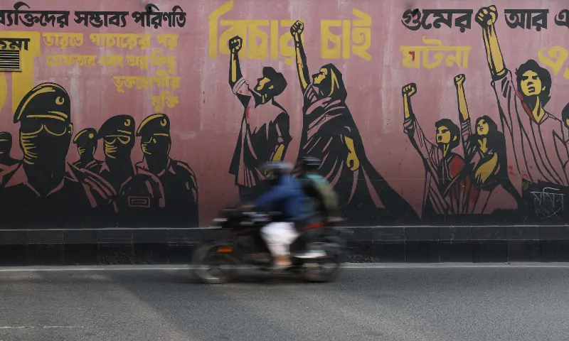 A motorcycle passes by a graffiti, the morning after the 13th general election, in Dhaka, Bangladesh on February 13, 2026. &mdash; Reuters