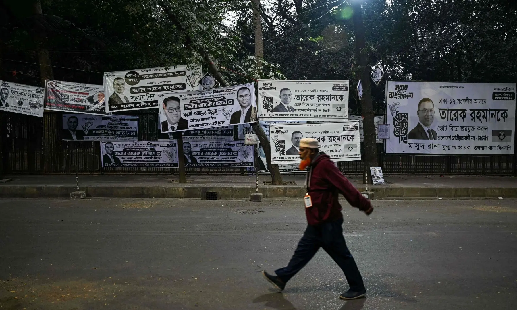 A man walks past campaign posters of Bangladesh Nationalist Party (BNP) chairman and election candidate Tarique Rahman outside his office as counting continues in Bangladesh&rsquo;s general election, in Dhaka on February 13, 2026. &mdash;AFP
