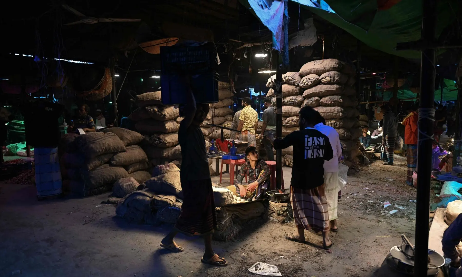 Vendors wait for customers at a market in Dhaka on February 13, 2026. &mdash;AFP