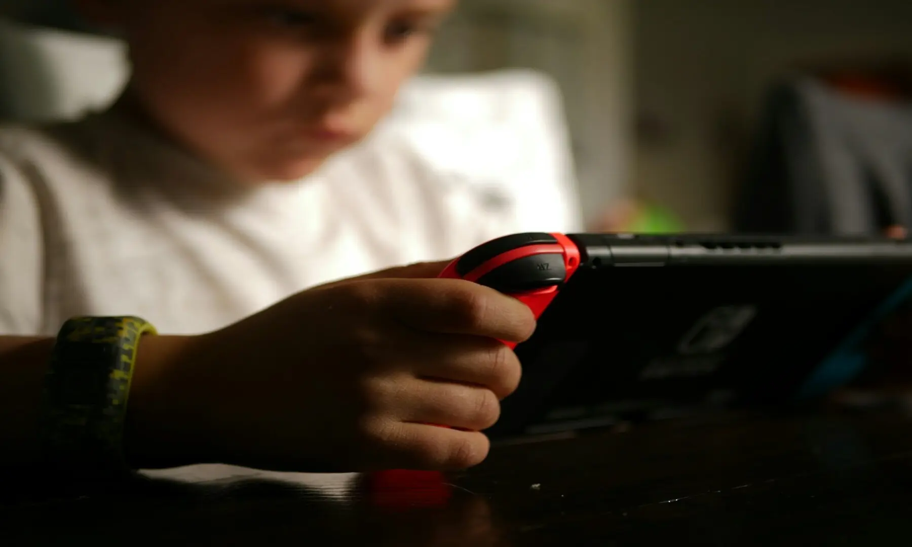 A kid playing a video game on a device. — Tyler Lagalo/ Unsplash
