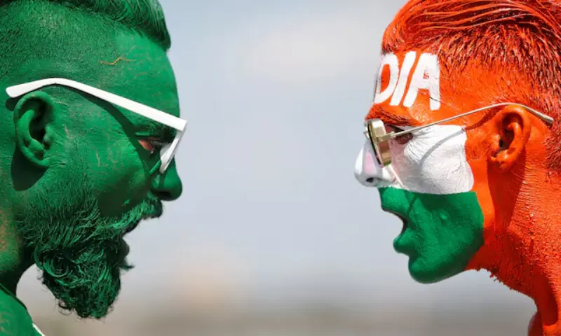 Cricket fans, with their faces painted in the Indian and Pakistani national flags colours. &mdash; Reuters/File