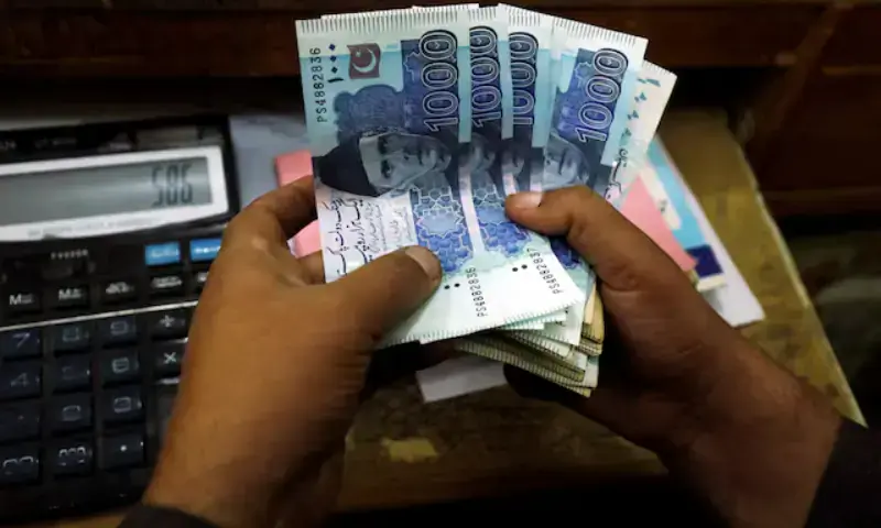 A trader counts Pakistani rupee notes at a currency exchange booth in Peshawar, Pakistan, on December 3, 2018. — Reuters/File A trader counts Pakistani rupee notes at a currency exchange booth in Peshawar, Pakistan, on December 3, 2018. — Reuters/File