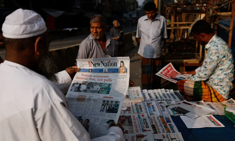 A man reads an English daily newspaper at a store, the morning after the 13th general election, in Dhaka, Bangladesh on February 13, 2026. &mdash; Reuters