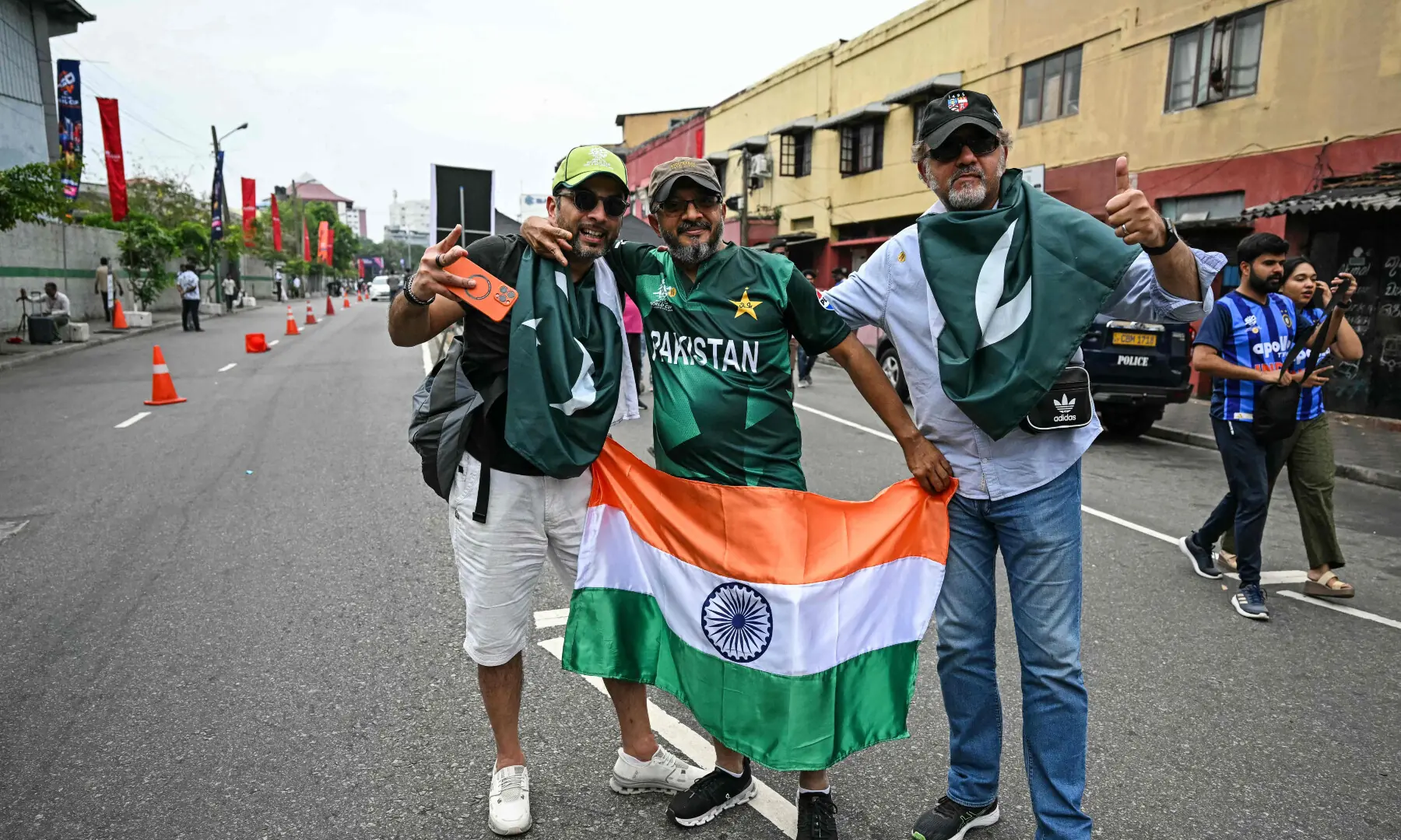 Fans pose with national flags of India and Pakistan upon their arrival before the start of their 2026 ICC Men&rsquo;s T20 Cricket World Cup group stage match at the R Premadasa Stadium in Colombo on Feb 15, 2026. &mdash; AFP
