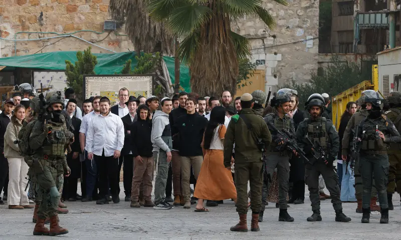 Israeli soldiers stand guard during a weekly settlers&rsquo; tour in Hebron, in the Israeli-occupied West Bank on February 14, 2026. &mdash; Reuters