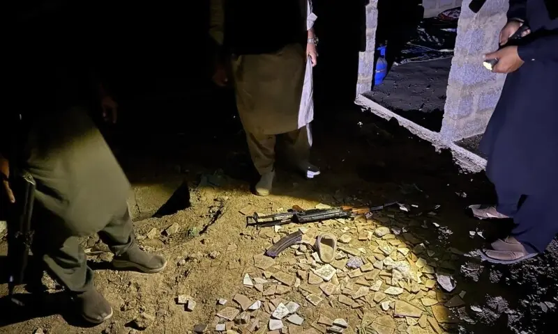 A Kalashnikov and a hand grenade recovered from a terrorist’s possession during the raid in Karachi’s Shah Latif Town. — Photo via author A Kalashnikov and a hand grenade recovered from a terrorist’s possession during the raid in Karachi’s Shah Latif Town. — Photo via author