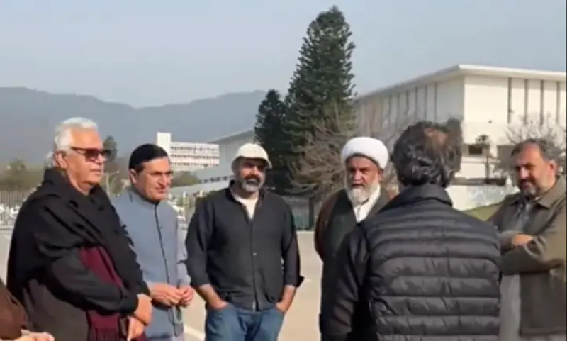 TTAP and PTI leaders stand at Parliament House, where they are staging a sit-in over Imran Khan&rsquo;s health concerns. &mdash; screengrab via X/BarristerGohar