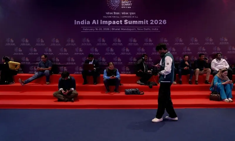 Visitors sit in front of a banner of India AI Impact Summit at Bharat Mandapam in New Delhi, India, February 17, 2026. &mdash;Reuters