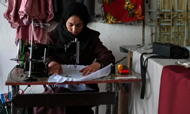 This photograph taken on January 20, 2026 shows Afghan tailoress Rahima Alavi embroidering a scarf at her boutique in Bamiyan. &mdash;AFP