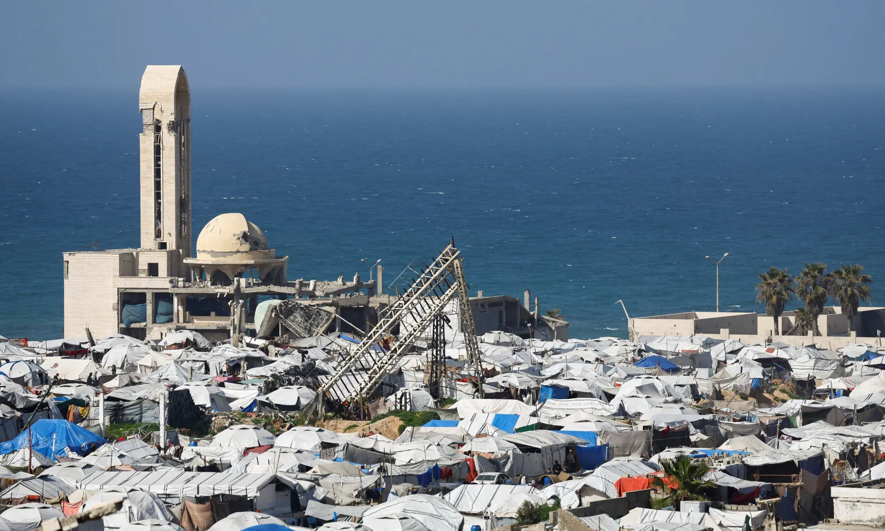 A mosque, destroyed during the two-year Israeli offensive, is surrounded by tents for displaced Palestinians, in Gaza City, on Feb 11, 2026. &mdash; Reuters
