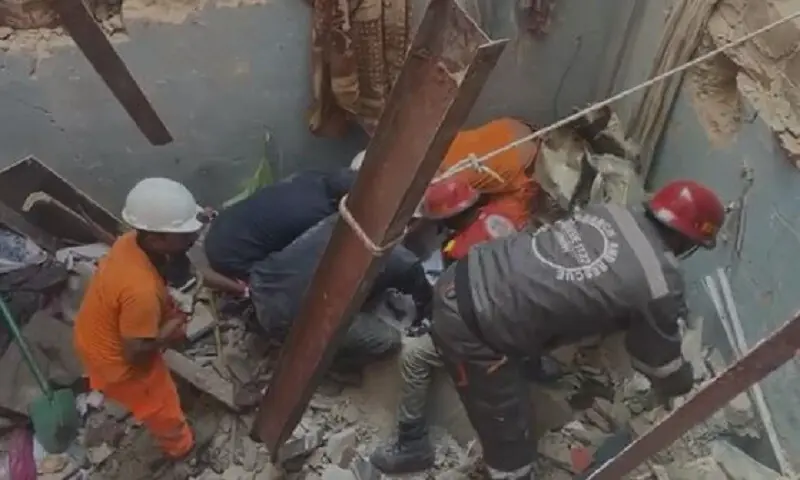 Rescue personnel sift through the rubble of the building following the collapse. &mdash; Rescue 1122