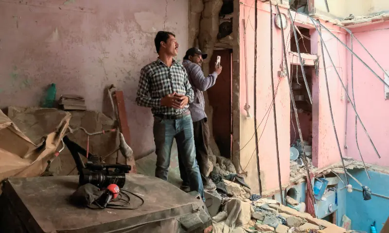 Members of the local media report at the site, after a gas cylinder blast caused a portion of a residential building to collapse in Karachi, on Feb 19, 2026. &mdash; Reuters