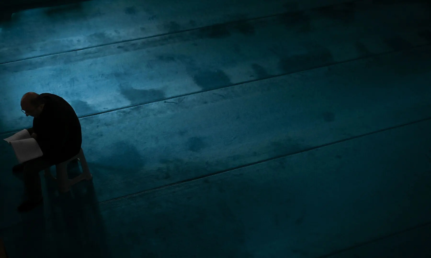 A Muslim devotee reads before offering prayers on the first day of Ramazan at a mosque in Pristina, Kosovo, on February 19, 2026. &mdash; Armend Nimani/ AFP