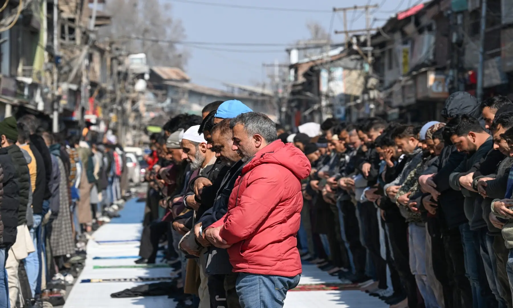 Muslims offer prayers on the first day of Ramazan, along a street in Indian-occupied Kashmir on February 19, 2026. &mdash; Tauseef Mustafa/ AFP