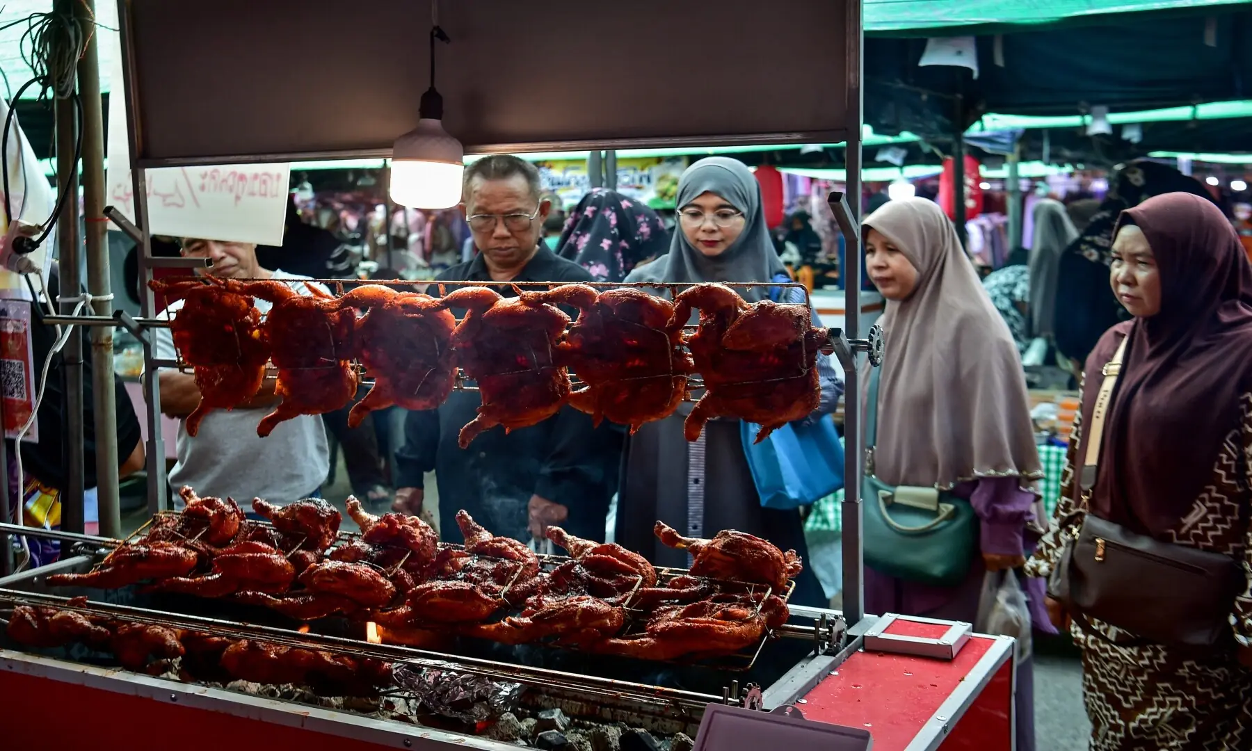 People buy iftar meals to break their fast on the first day of the holy fasting month of Ramazan at a market in the southern Thai province of Narathiwat on February 19, 2026. &mdash; Madaree Tohlala/ AFP