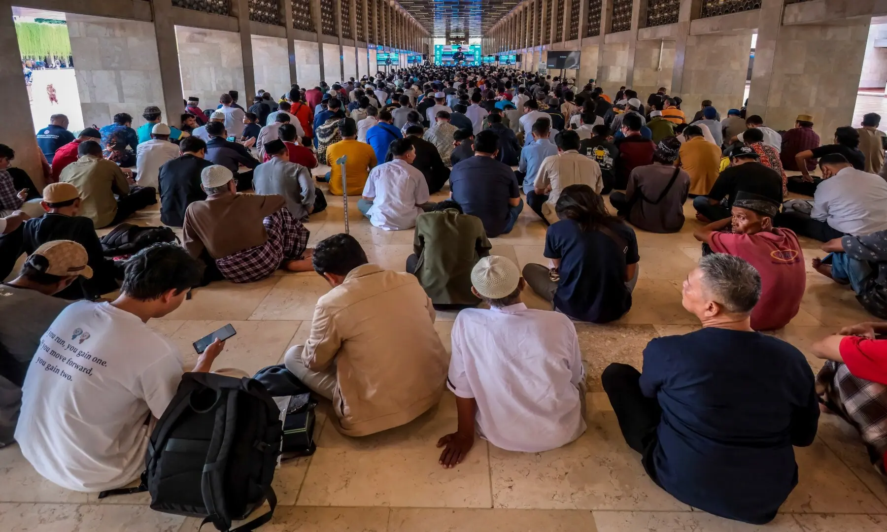 Muslim devotees gather to listen to a religious lecture while waiting to break their fast at Istiqlal Mosque in Jakarta on February 19, 2026. &mdash; Bay Ismoyo / AFP