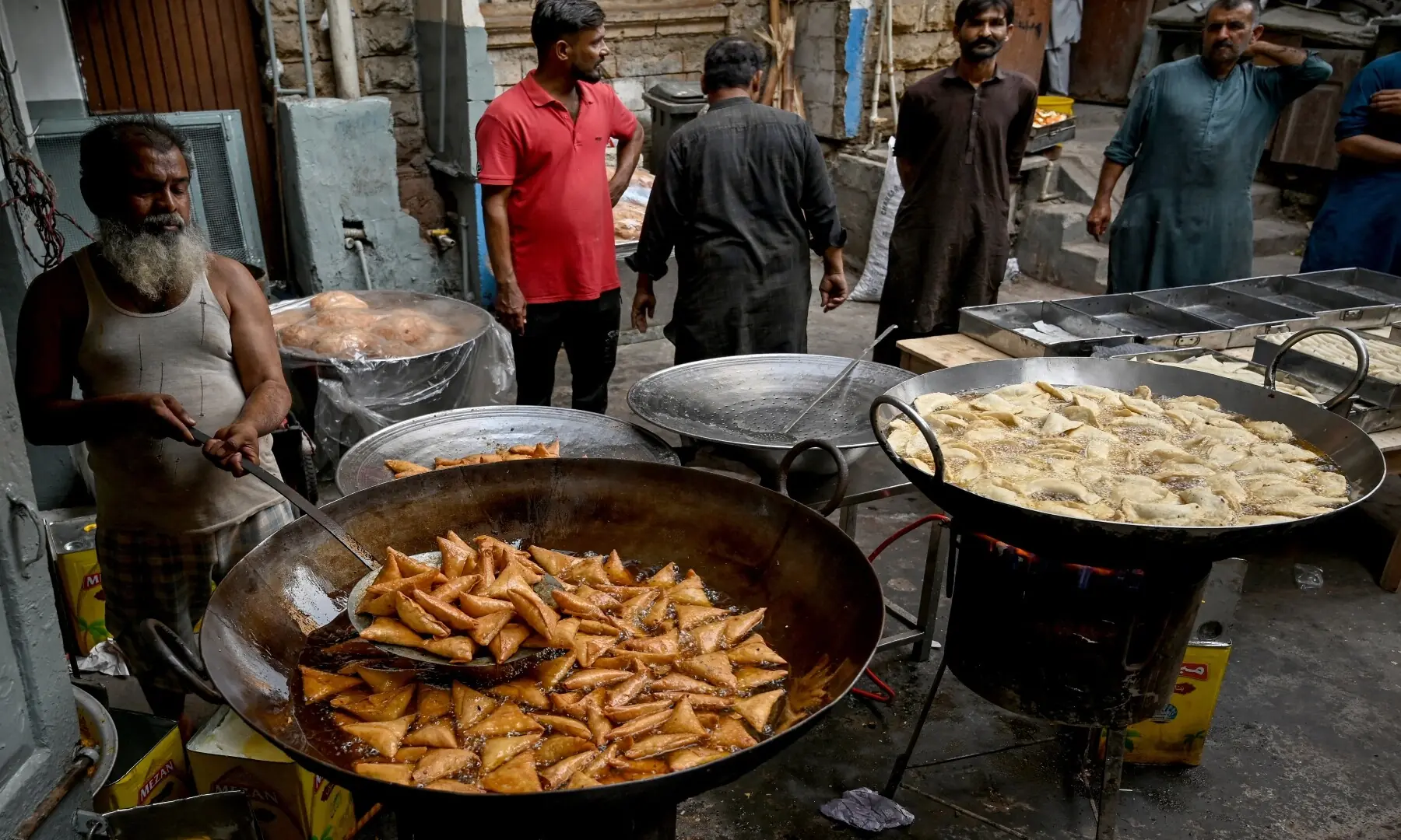 Vendors prepare fritters for iftar meals on the first day of Ramazan in Karachi on February 19, 2026. &mdash; Rizwan Tabassum / AFP