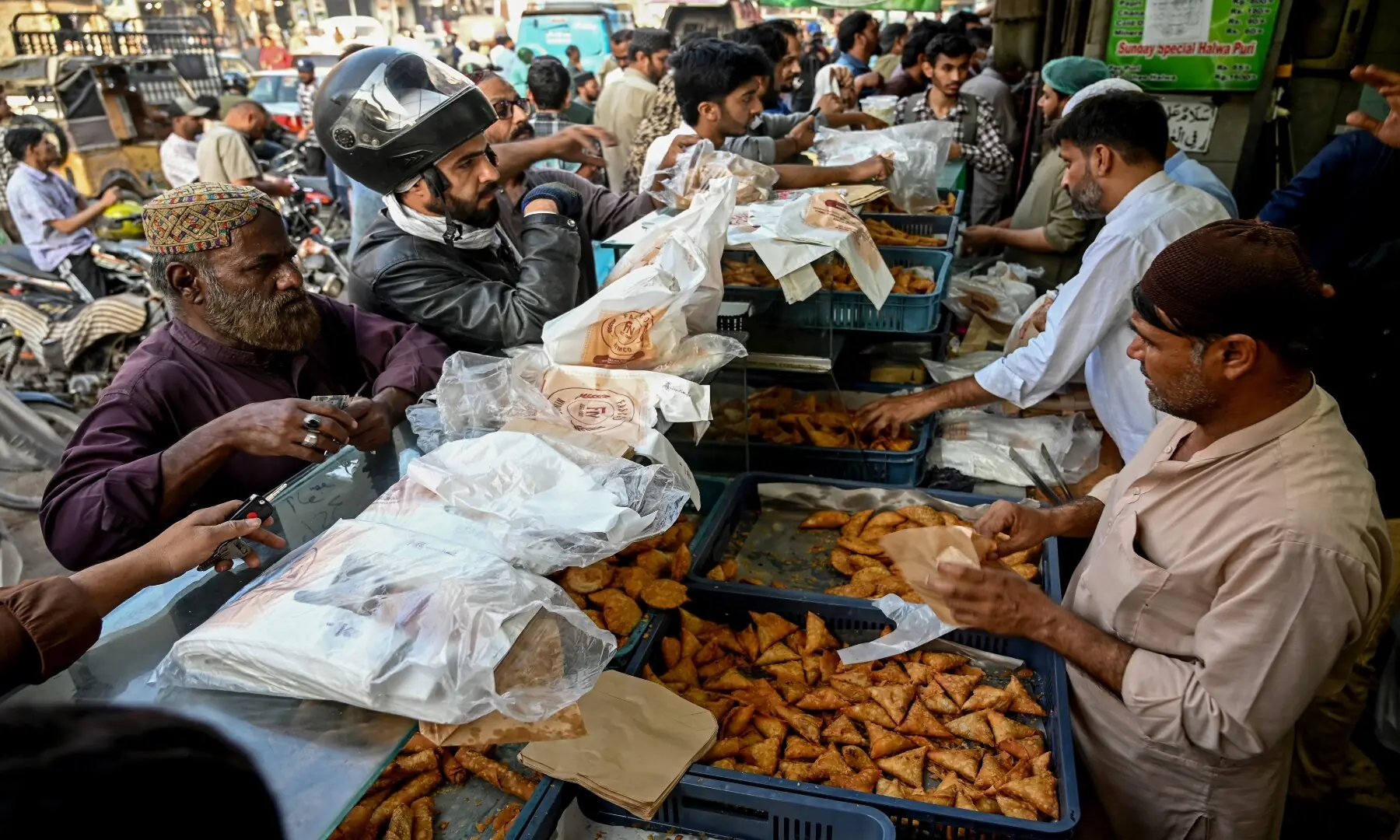 People buy fritters for iftar meals to break their fast on the first day of Ramazan in Karachi on February 19, 2026. &mdash; Rizwan Tabassum / AFP