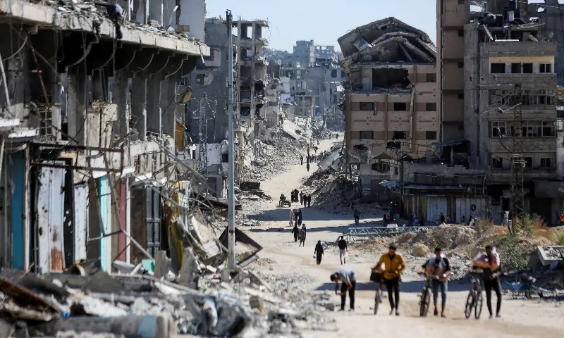 Palestinians make their way in a devasted neighborhood, amid the ongoing Israel-Hamas conflict, in Gaza City, October 24, 2024. — Reuters/File Palestinians make their way in a devasted neighborhood, amid the ongoing Israel-Hamas conflict, in Gaza City, October 24, 2024. — Reuters/File