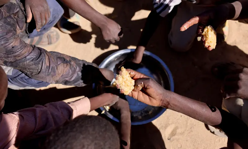 Orphaned Sudanese refugee children from al-Fashir share a free meal of pasta and meat provided by the &ldquo;Group Kitchen Project,&rdquo; led by Najwa Isa Adam, inside the Tine transit camp in eastern Chad, as they flee ongoing clashes between the paramilitary Rapid Support Forces (RSF) and the Sudanese army on November 22, 2025. &mdash; Reuters/File