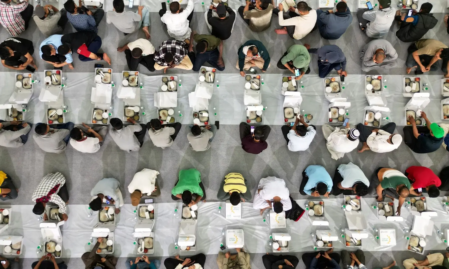 Workers wait to break their fast during the holy month of Ramazan inside a hall in Kuwait City on February 19, 2026. Muslims throughout the world are marking the month of Ramazan, the holiest month in the Islamic calendar, during which devotees fast from dawn until dusk.  &mdash;AFP