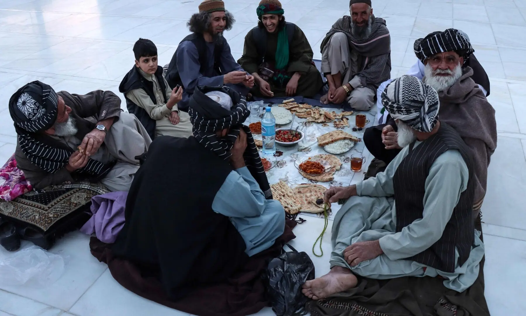 Muslim devotees wait to break their fast on the first day of the Islamic holy month of Ramazan at Jami Masjid, also known as the Great Mosque of Herat in Herat on February 19, 2026. &mdash;AFP