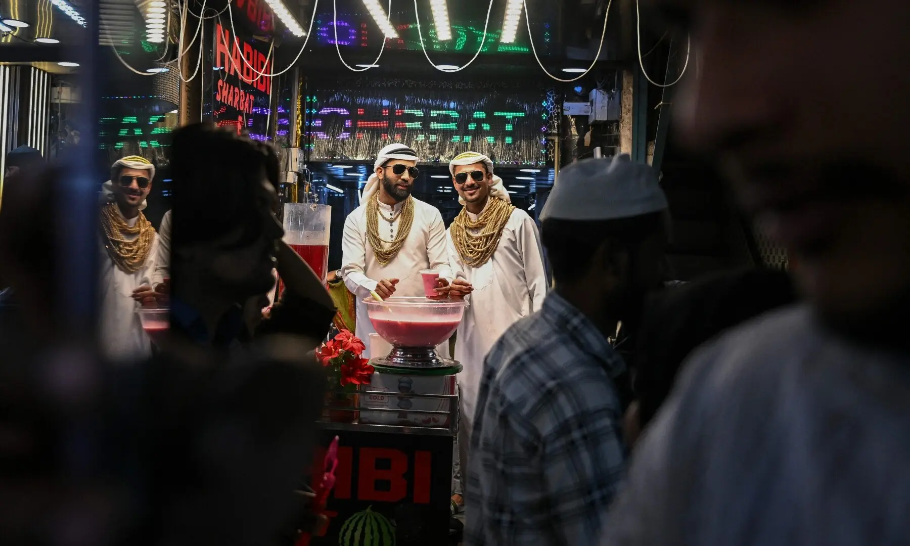 Shopkeepers dressed as Arab sheikhs sell cold drinks on the first day of the Islamic holy month of Ramazan near the Jama Masjid in New Delhi on February 19, 2026. &mdash;AFP
