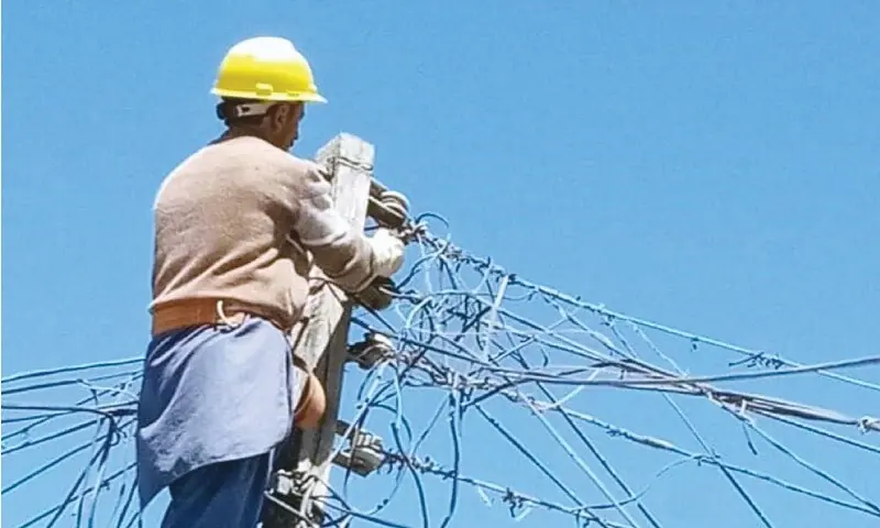 A file photo of an electrician working on power lines.&mdash;Dawn/file